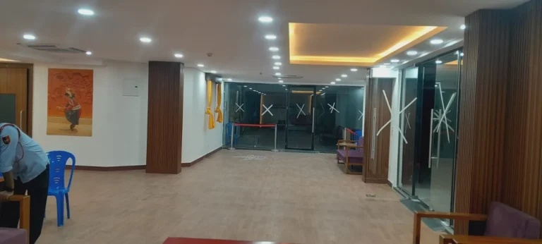 Office lobby with cove lighting, glass partitions and wooden flooring