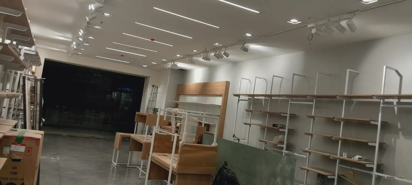 Completed retail store interior with display racks and ceiling lights