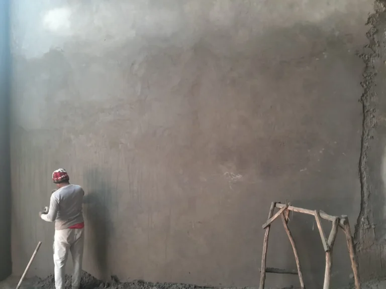 Mason finishing a large plastered wall